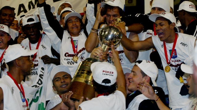 Players of Colombia's Once Caldas, celeberate with the trophy after defeating Argentina's Boca Juniors, during the  Copa Libertadores final in Manizales, Colombia, Thursday, July 1, 2004. Caldas won. (AP Photo/Fernando Vergara)