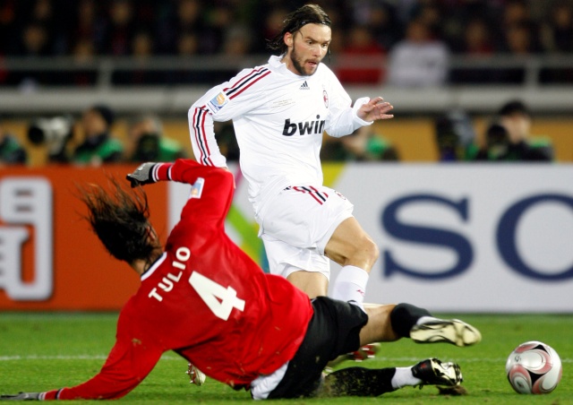 AC Milan's defender Marek Jankulovski, top, of Czech fights for the ball with Urawa Reds' defender Marcus Tulio Tanaka during their semi-final soccer match at the FIFA Club World Cup soccer championship in Yokohama, near Tokyo, Japan, Thursday, Dec. 13, 2007. (AP Photo/Shizuo Kambayashi)