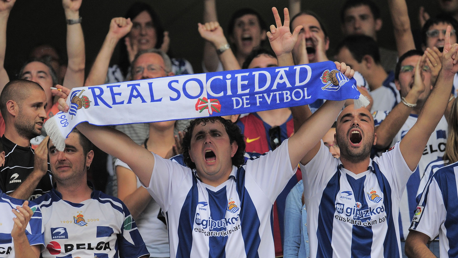 Supporters cheer Real Sociedad at the end of the match against Barcelona during their Spanish La Liga soccer match at Anoeta stadium in San Sebastian, northern Spain, Saturday Sept. 10, 2011. Barcelona and Real Sociedad tied 2-2. (AP Photo/Alvaro Barrientos)