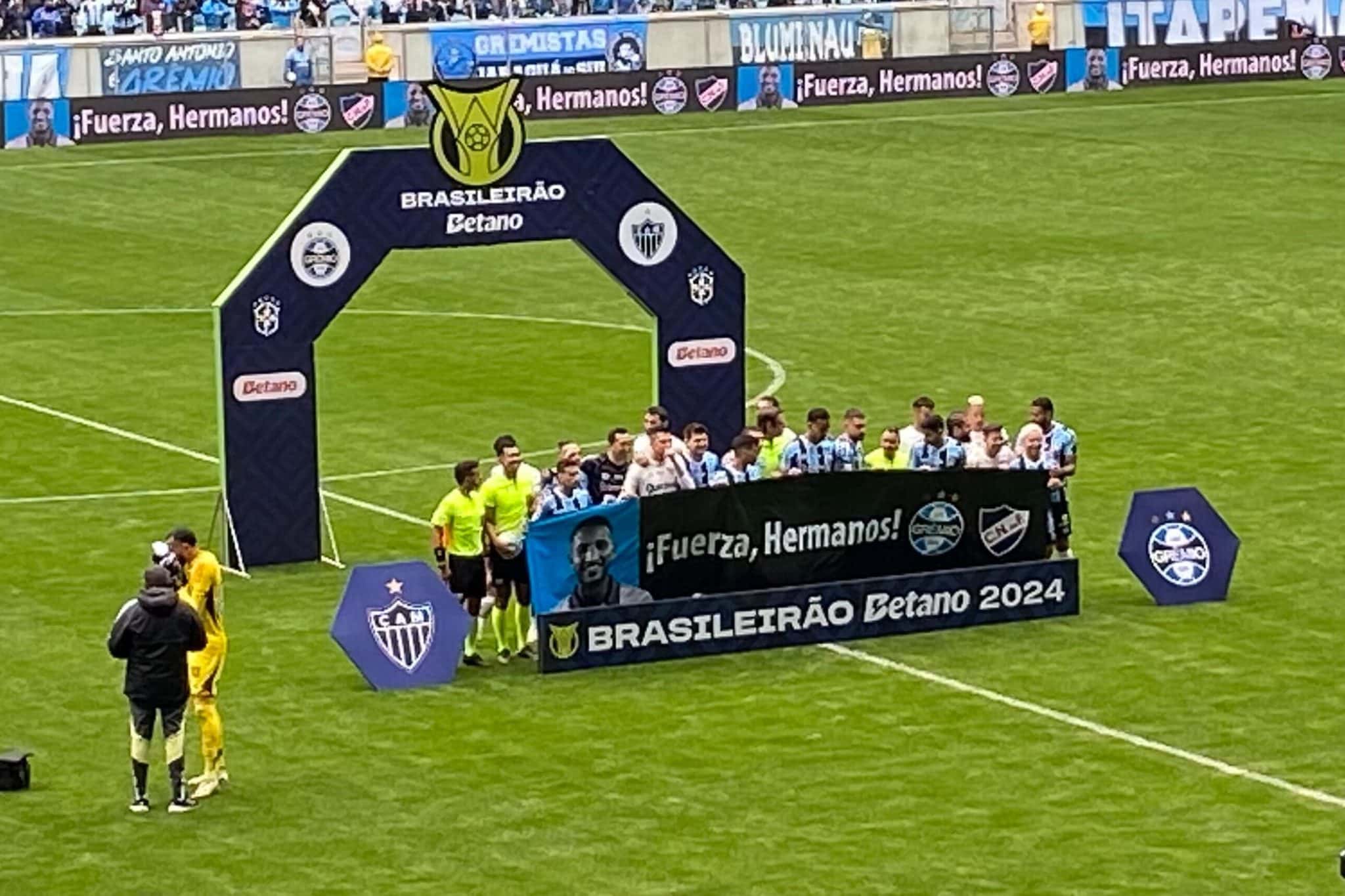 Jogadores de Gr&ecirc;mio e Atl&eacute;tico-MG com faixa em homenagem a Izquierdo