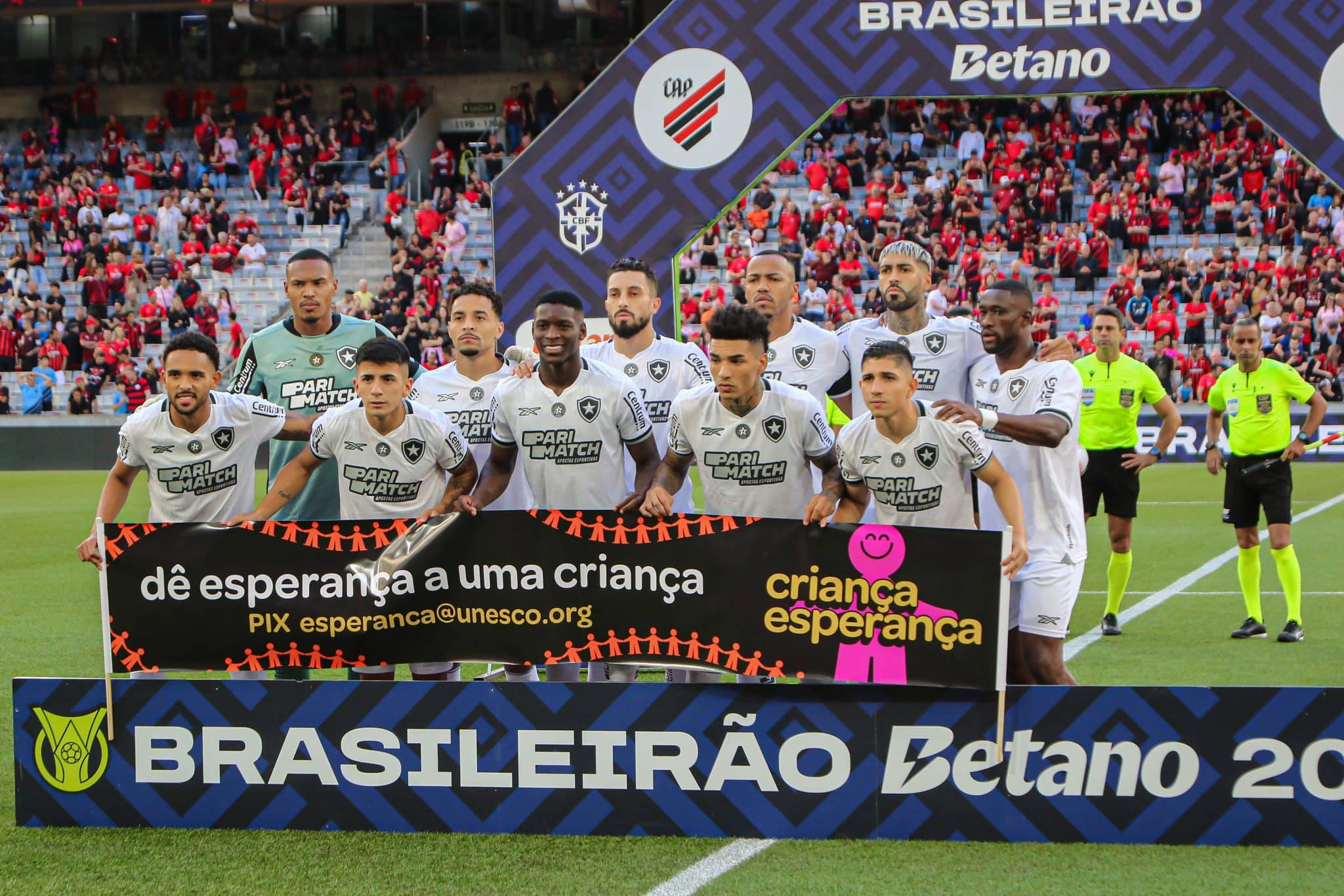 Time do Botafogo perfilado no gramado da Ligga Arena