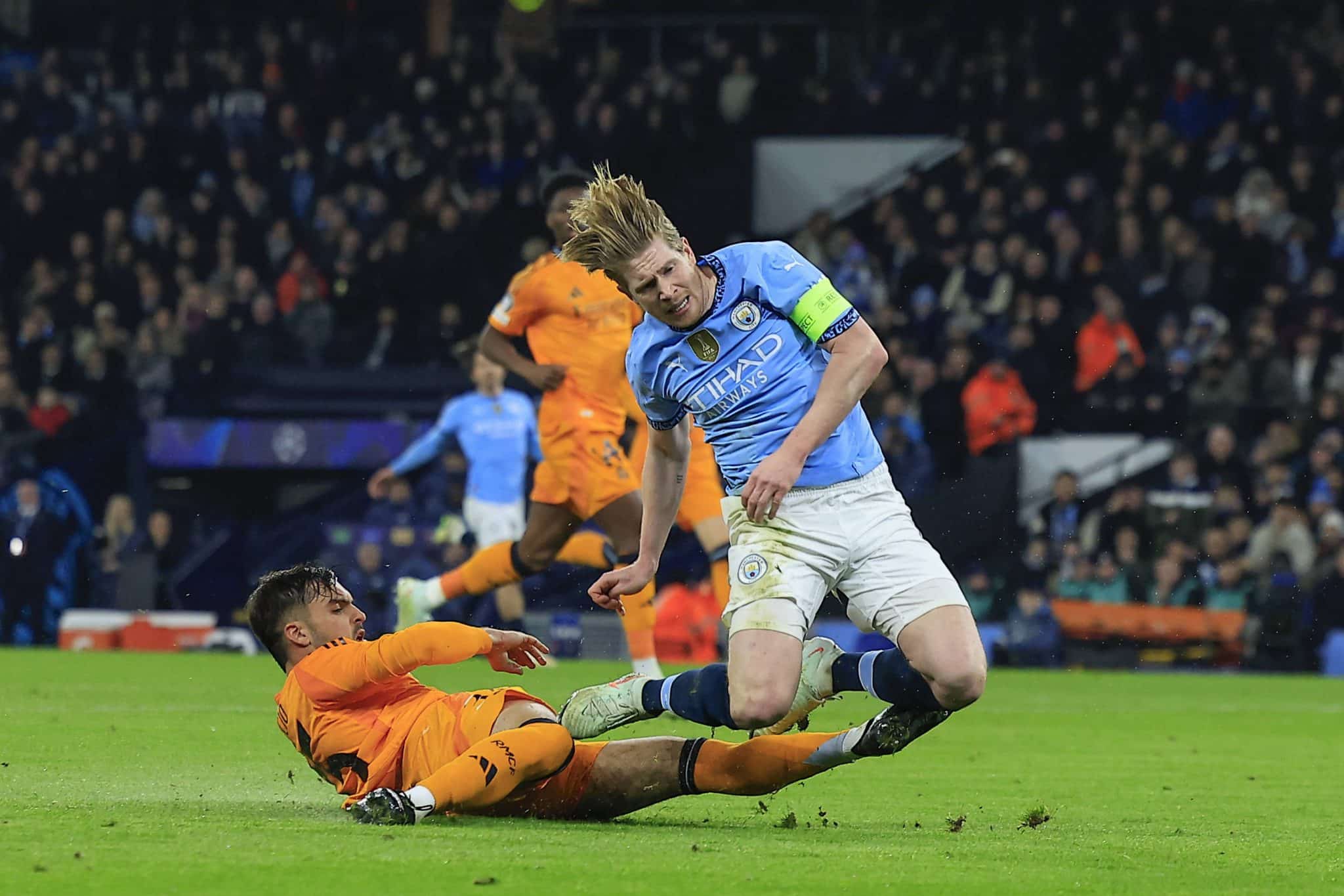 Asencio d&aacute; carrinho em Kevin de Bruyne durante partida entre Real Madrid e Manchester City